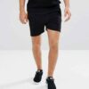 Lightweight drawstring beach shorts with vibrant print. Note fine stitching and soft, textured fabric. Summer casual wear. -