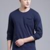 Close-up of a navy blue t-shirt with a white logo print. Cotton fabric texture, clean stitching detail. Short sleeve crew nec
