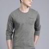 Close-up of a navy blue t-shirt with a white logo print. Cotton fabric texture, clean stitching detail. Short sleeve crew nec