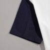 Close-up of event tee shirts. Soft cotton knit, vibrant print, clean seams. Short-sleeve, crew neck. Dark blue and white. - V