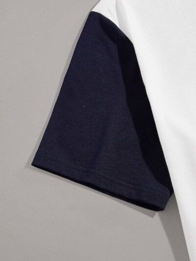 Close-up of event tee shirts. Soft cotton knit, vibrant print, clean seams. Short-sleeve, crew neck. Dark blue and white. - V