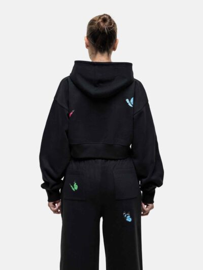 Women's tracksuit set. Close-up shows soft, brushed fleece texture. Heather grey top & matching bottoms, detailed stitching.