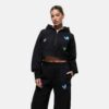 Women's tracksuit set. Close-up shows soft, brushed fleece texture. Heather grey top & matching bottoms, detailed stitching.
