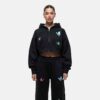 Women's tracksuit set. Close-up shows soft, brushed fleece texture. Heather grey top & matching bottoms, detailed stitching.