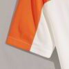 Close-up cotton t-shirt, vibrant custom print. Fine stitching detail, soft fabric texture visible. Promotional garment, brigh