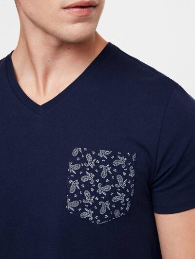 Close-up of a custom-printed tee. Smooth, dense cotton, neat stitching. Royal blue hue, ribbed crew neck, and crisp graphic.