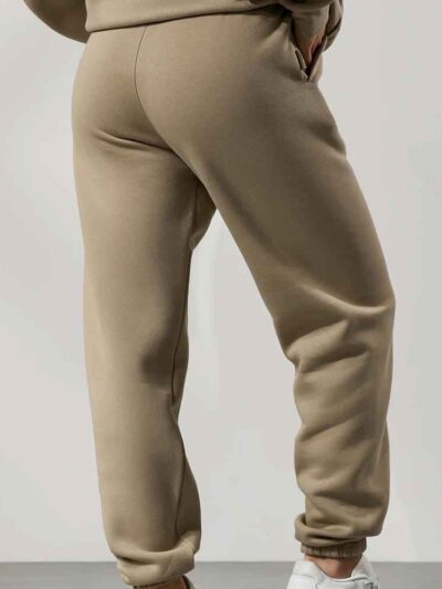 Women's tracksuit set. Close-up on soft fabric texture, visible stitching. Versatile for all seasons, comfortable fit. Sporty