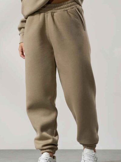 Women's tracksuit set. Close-up on soft fabric texture, visible stitching. Versatile for all seasons, comfortable fit. Sporty