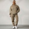 Women's tracksuit set. Close-up on soft fabric texture, visible stitching. Versatile for all seasons, comfortable fit. Sporty