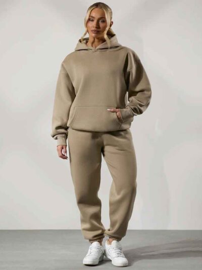 Women's tracksuit set. Close-up on soft fabric texture, visible stitching. Versatile for all seasons, comfortable fit. Sporty