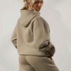 Women's tracksuit set. Close-up on soft fabric texture, visible stitching. Versatile for all seasons, comfortable fit. Sporty
