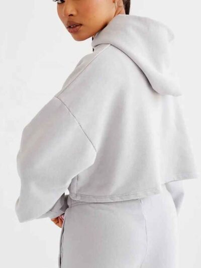 Woman's street style tracksuit. Embroidered logo detail. Soft, looped terry knit texture. Relaxed fit, neutral color tones. P