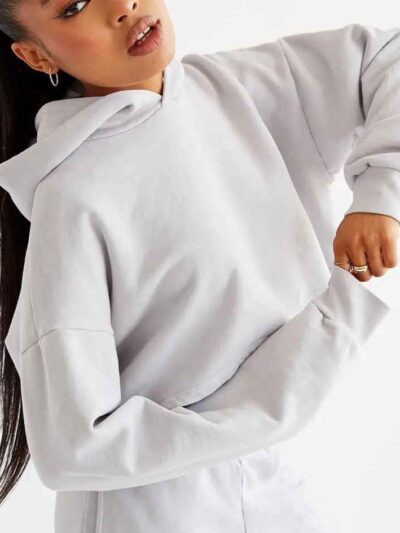 Woman's street style tracksuit. Embroidered logo detail. Soft, looped terry knit texture. Relaxed fit, neutral color tones. P