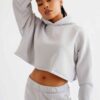 Woman's street style tracksuit. Embroidered logo detail. Soft, looped terry knit texture. Relaxed fit, neutral color tones. P