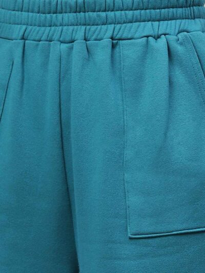 Women's tracksuit set: close-up showing soft, heather gray fabric, elastic waistband joggers, and neat stitching. Athleisure