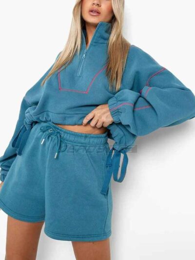 Women's two-piece tracksuit with vibrant all-over print. Soft, textured fabric. Detailed stitching visible on cuffs and waist