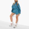Women's two-piece tracksuit with vibrant all-over print. Soft, textured fabric. Detailed stitching visible on cuffs and waist