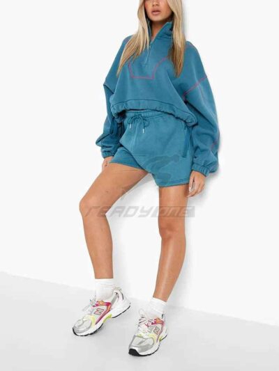 Women's two-piece tracksuit with vibrant all-over print. Soft, textured fabric. Detailed stitching visible on cuffs and waist