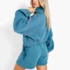 Women's two-piece tracksuit with vibrant all-over print. Soft, textured fabric. Detailed stitching visible on cuffs and waist