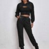 Women's two-piece tracksuit with vibrant all-over print. Soft, textured fabric. Detailed stitching visible on cuffs and waist