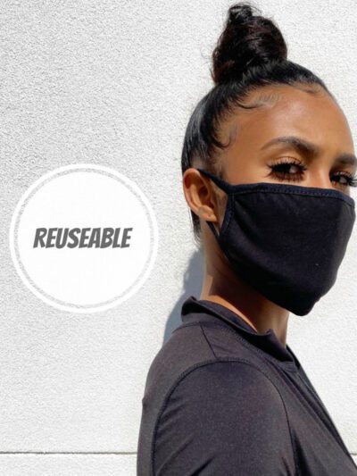 Soft, reusable face mask in a cheerful floral print. Close-up shows fine cotton weave and durable stitching. Washable and com