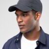 Navy polo cap with detailed embroidered golf scene. Notice the textured pique knit fabric and vibrant stitching of the design