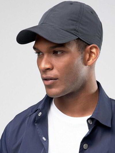 Navy polo cap with detailed embroidered golf scene. Notice the textured pique knit fabric and vibrant stitching of the design