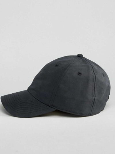 Navy polo cap with detailed embroidered golf scene. Notice the textured pique knit fabric and vibrant stitching of the design