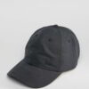 Navy polo cap with detailed embroidered golf scene. Notice the textured pique knit fabric and vibrant stitching of the design
