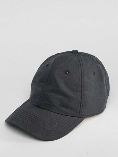 Navy polo cap with detailed embroidered golf scene. Notice the textured pique knit fabric and vibrant stitching of the design