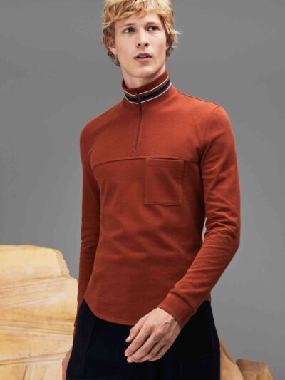 Zippered polo shirt. Soft-touch cotton fabric, stand-up collar, subtle texture. Fine stitching detail visible on a custom gar