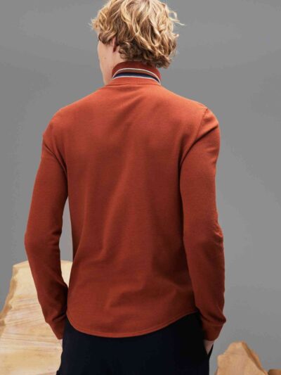 Zippered polo shirt. Soft-touch cotton fabric, stand-up collar, subtle texture. Fine stitching detail visible on a custom gar