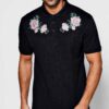 Polo shirts with delicate floral embroidery, soft textured fabric, and subtle stitching. High-quality cotton blend. Perfect f