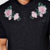 Polo shirts with delicate floral embroidery, soft textured fabric, and subtle stitching. High-quality cotton blend. Perfect f