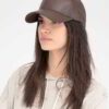 Close-up of brown faux leather cap. Textured fabric, precise stitching. Custom logo option shown, structured crown. - View 1