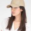 Close-up of brown faux leather cap. Textured fabric, precise stitching. Custom logo option shown, structured crown. - View 6