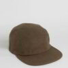 Close-up of a five-panel cap. Premium construction, tight stitching, possibly cotton twill. Adjustable snapback, green underv