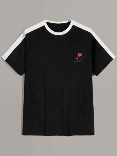 White t-shirt with vibrant floral print, striped panel, and color-blocked design. Soft, breathable knit fabric; clean, durabl