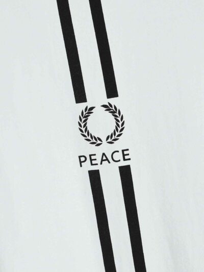 Striped ringer tee featuring custom letter graphic. Soft knit texture, durable stitched seams. Contrasting collar & cuffs add