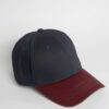 Close-up of a textured twill golf visor in navy with crisp white custom logo embroidery. Curved brim, detailed stitching, adj