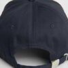 Close-up of a textured twill golf visor in navy with crisp white custom logo embroidery. Curved brim, detailed stitching, adj