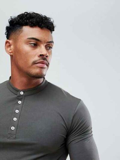 Close-up of navy golf polo shirt showing fine pique knit texture, crisp collar stitching, and subtle tailored fit. Ideal for