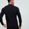 Close-up of navy golf polo shirt showing fine pique knit texture, crisp collar stitching, and subtle tailored fit. Ideal for