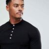 Close-up of navy golf polo shirt showing fine pique knit texture, crisp collar stitching, and subtle tailored fit. Ideal for