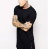 Black elongated tee. Soft, drapey fabric. Note the stylish side zipper detail and clean stitching. Minimalist, modern look. -