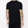 Black elongated tee. Soft, drapey fabric. Note the stylish side zipper detail and clean stitching. Minimalist, modern look. -