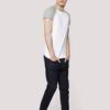 Close-up on a smooth, finely-knitted t-shirt. Notice the tight stitching and soft drape, hints of premium cotton in solid col