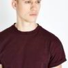 Burgundy t-shirt close-up. Fine custom embroidery detail on soft, textured cotton knit. High-quality short-sleeve top. - View