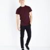 Burgundy t-shirt close-up. Fine custom embroidery detail on soft, textured cotton knit. High-quality short-sleeve top. - View