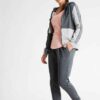 Crimson and charcoal football training tracksuit. Close-up shows breathable fabric, reinforced stitching. Jacket and pants se